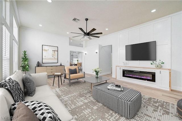 living room with ceiling fan and light hardwood / wood-style floors