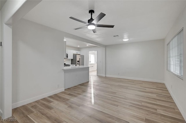 unfurnished living room with ceiling fan and light hardwood / wood-style flooring