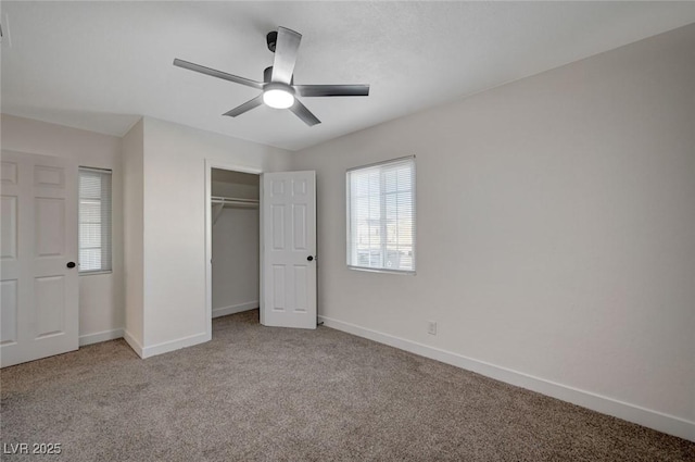 unfurnished bedroom featuring light colored carpet, a closet, and ceiling fan