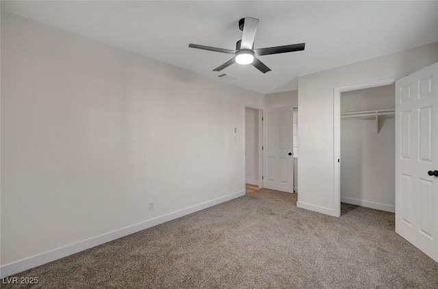 unfurnished bedroom featuring ceiling fan, a closet, and light carpet