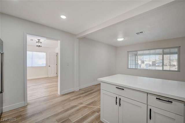 kitchen with white cabinets and light wood-type flooring