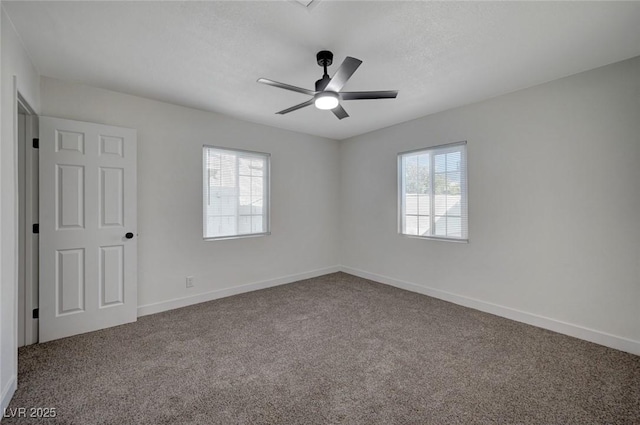 empty room with ceiling fan and carpet flooring