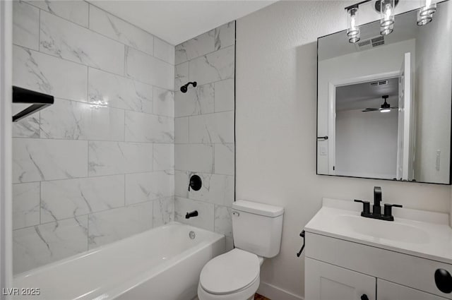 full bathroom with ceiling fan, vanity, toilet, and tiled shower / bath combo