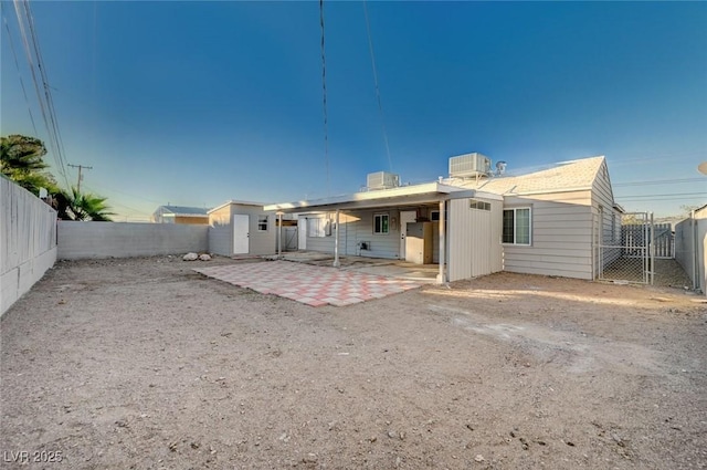 back of property featuring central AC unit and a patio