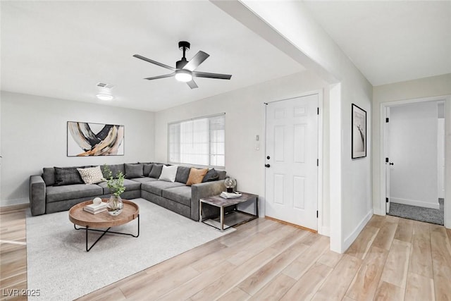 living room featuring ceiling fan and light hardwood / wood-style floors