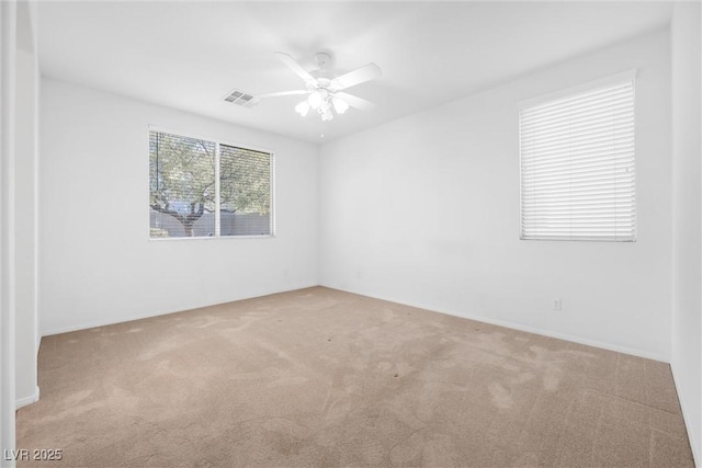 carpeted empty room featuring ceiling fan