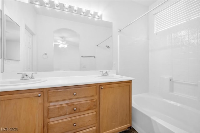 bathroom featuring bathing tub / shower combination, ceiling fan, and vanity