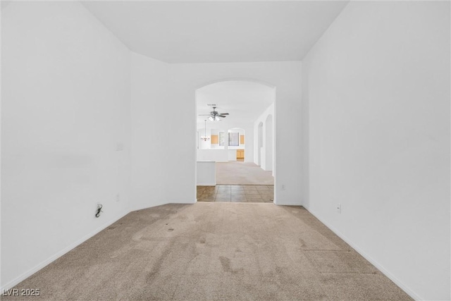 unfurnished room with ceiling fan and light carpet