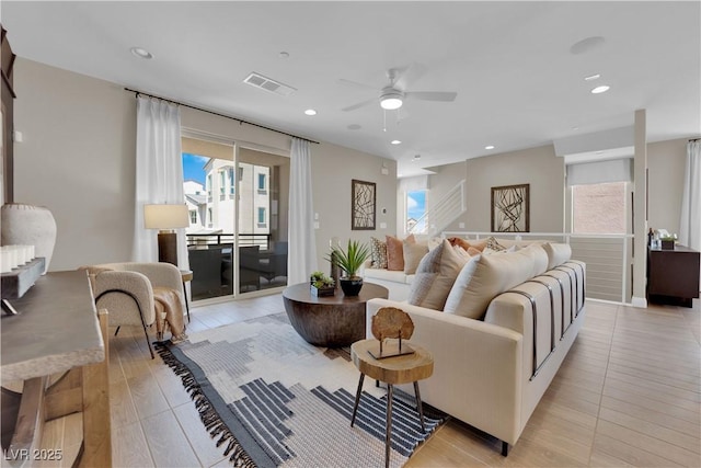 living room with ceiling fan and light wood-type flooring