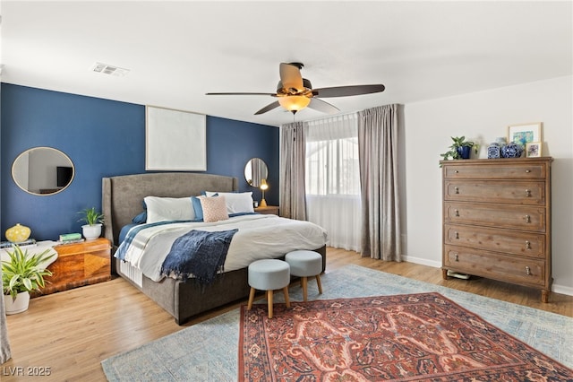 bedroom with light hardwood / wood-style floors and ceiling fan