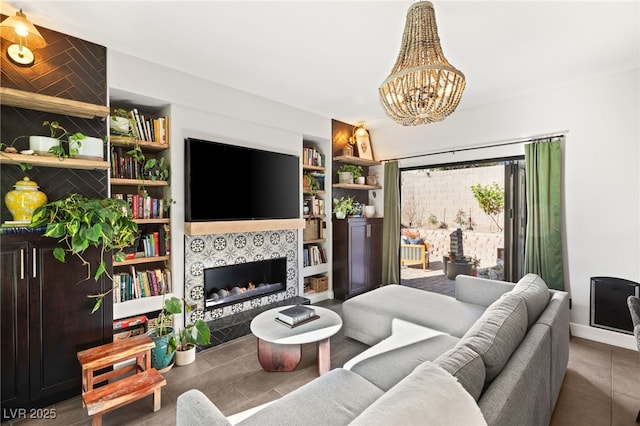 living room featuring tile patterned floors, a chandelier, and a fireplace