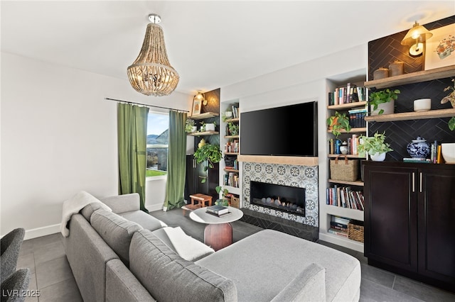 tiled living room featuring a tiled fireplace and an inviting chandelier