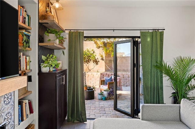 doorway to outside with light tile patterned floors