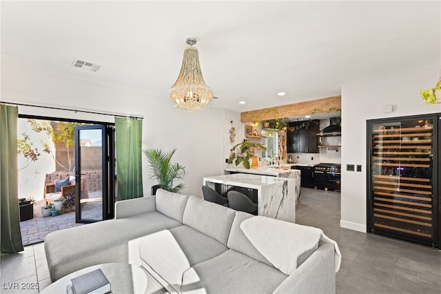 living room featuring wine cooler and an inviting chandelier