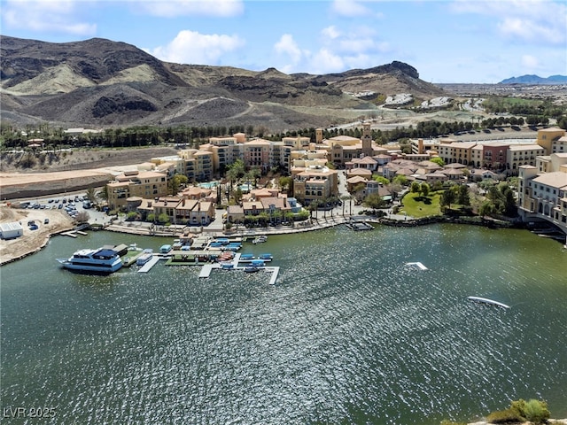 drone / aerial view featuring a water and mountain view