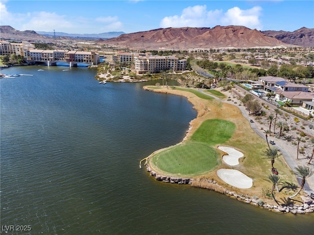 birds eye view of property with a water and mountain view