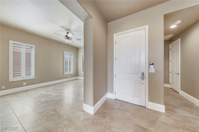 tiled foyer with ceiling fan