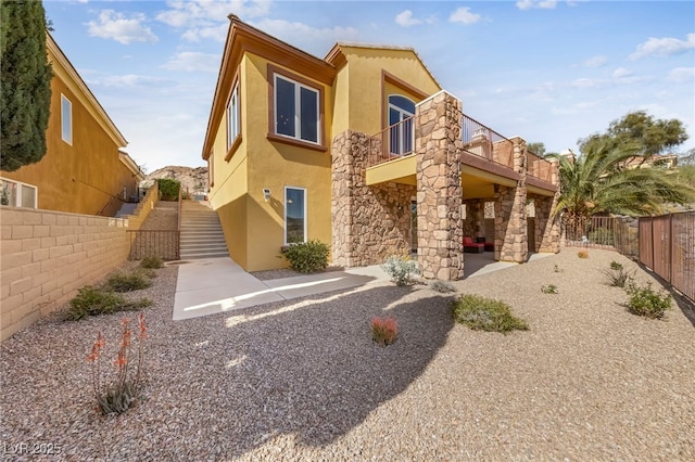 back of house with a patio area and a balcony