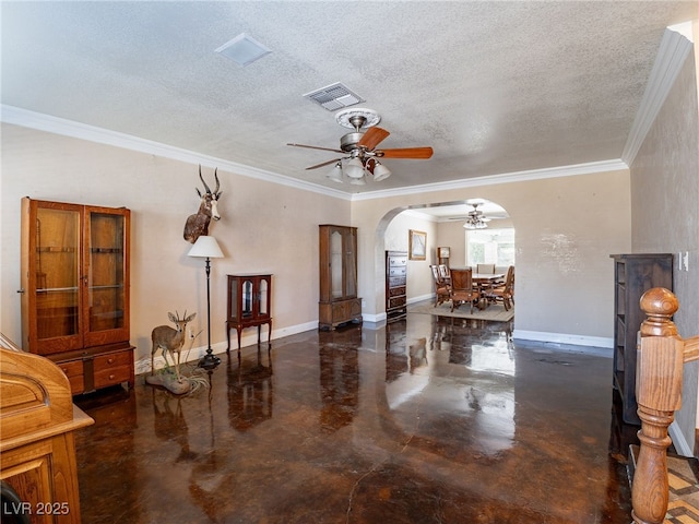 living room featuring ceiling fan, a textured ceiling, and ornamental molding