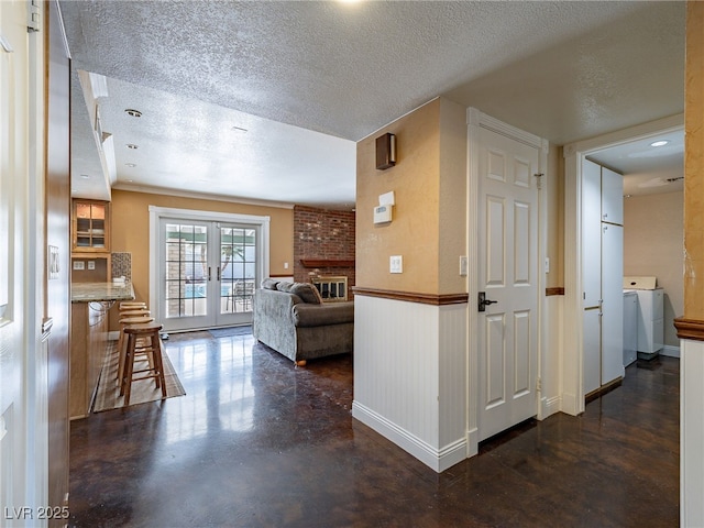 hall with a textured ceiling and french doors