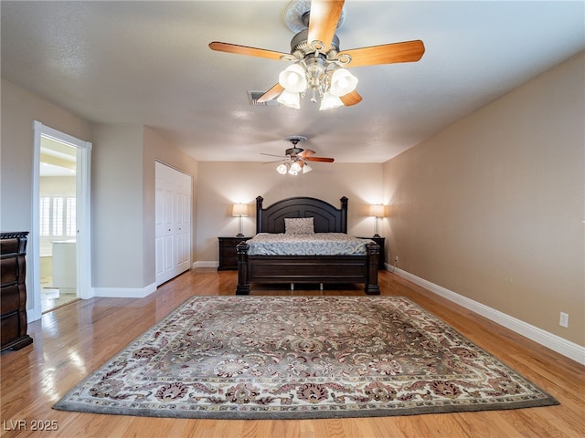 bedroom with ceiling fan, a closet, and hardwood / wood-style floors