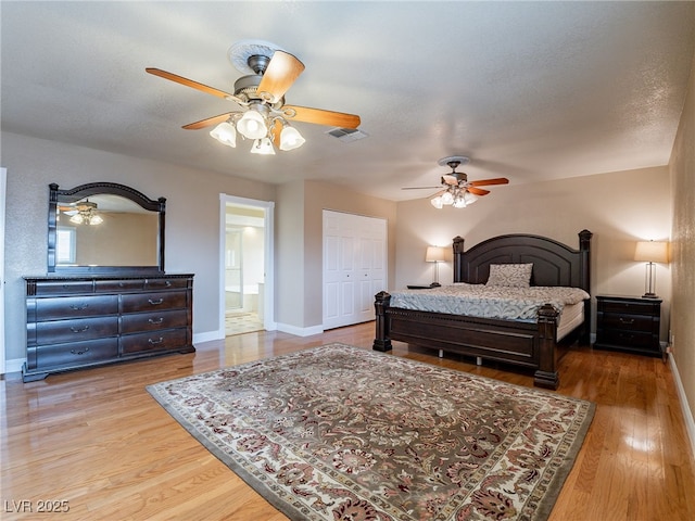 bedroom featuring connected bathroom, ceiling fan, hardwood / wood-style floors, a textured ceiling, and a closet