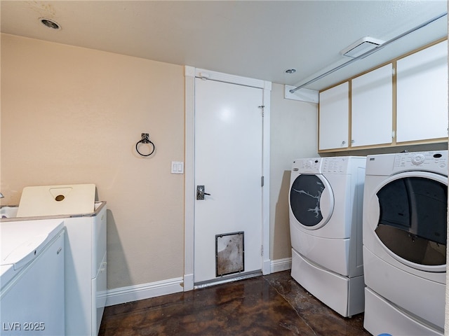 laundry room featuring cabinets and separate washer and dryer