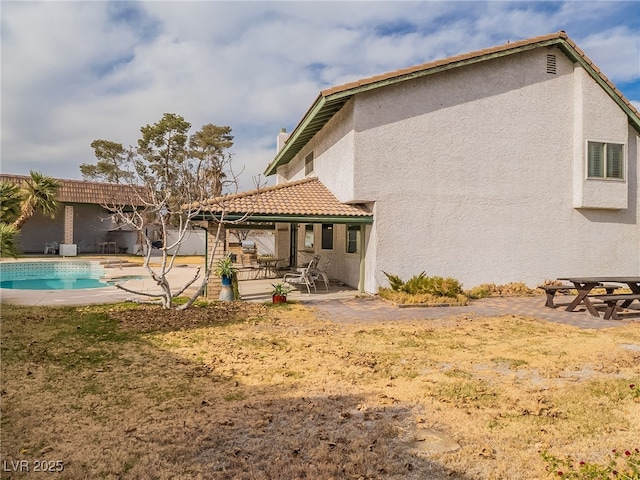 back of property featuring a patio