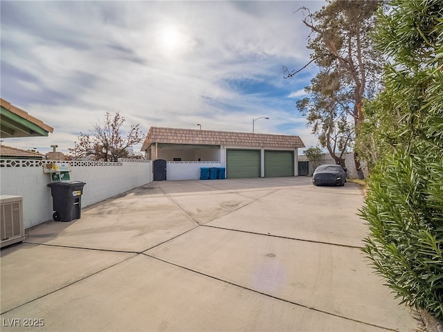 exterior space featuring an outdoor structure, central AC unit, and a garage