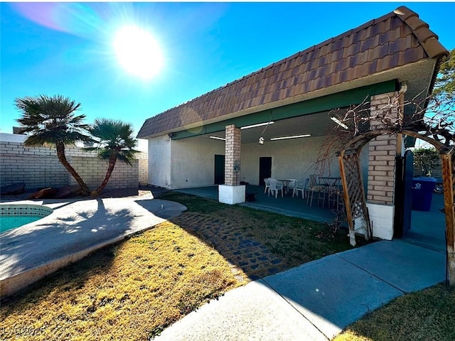 exterior space with a fenced in pool and a patio