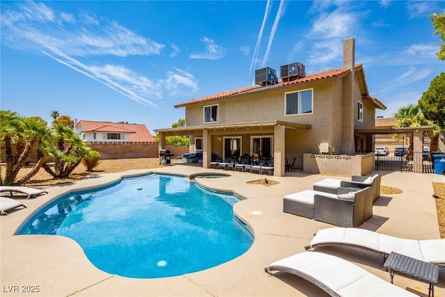 view of swimming pool with central air condition unit, outdoor lounge area, a bar, and a patio