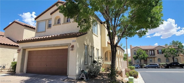 mediterranean / spanish-style house with a garage