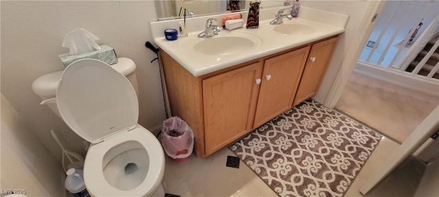 bathroom with tile patterned floors, vanity, and toilet