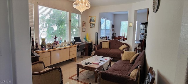 sitting room featuring a notable chandelier and light tile patterned floors