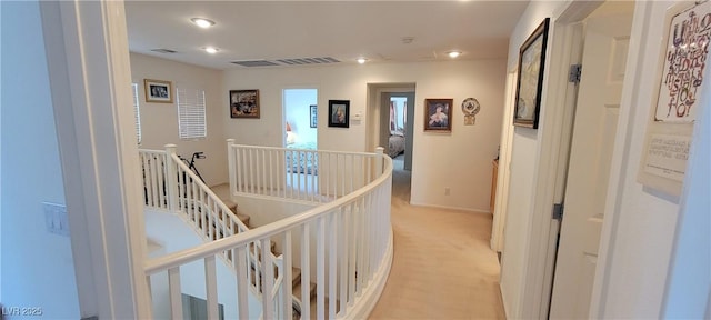 hallway featuring light carpet