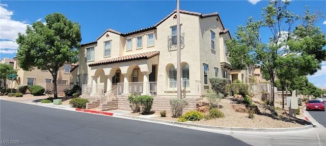 mediterranean / spanish house with a porch