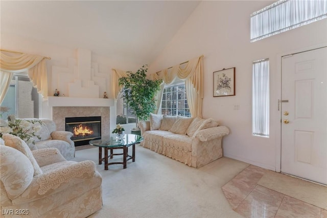 carpeted living room featuring a high ceiling