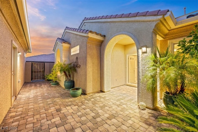 view of exterior entry at dusk