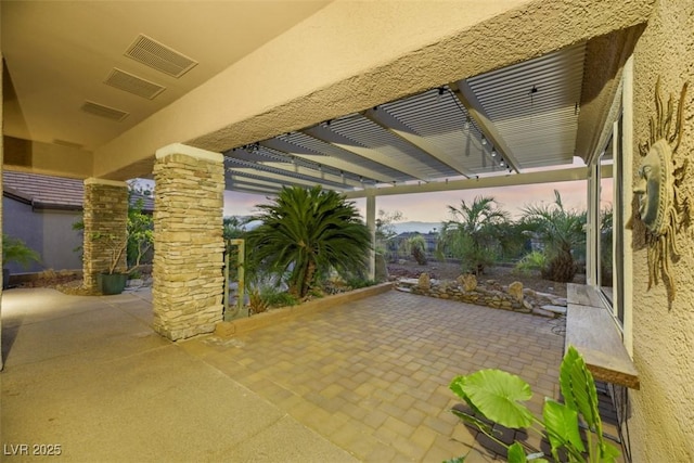 patio terrace at dusk with a pergola