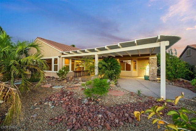 back house at dusk with a carport