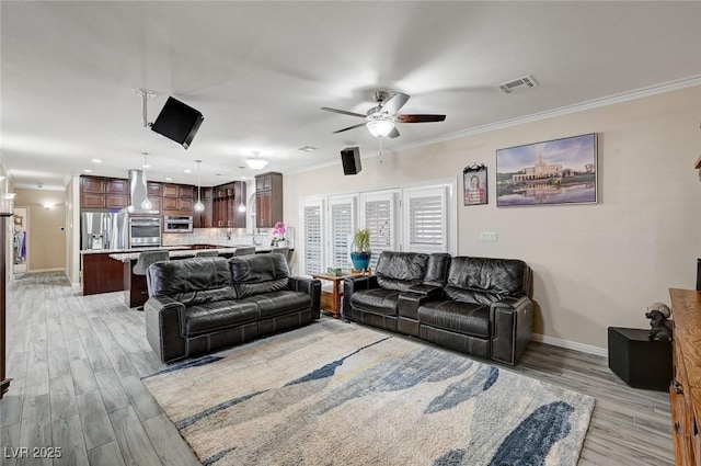 living room featuring light wood-type flooring, ceiling fan, and ornamental molding