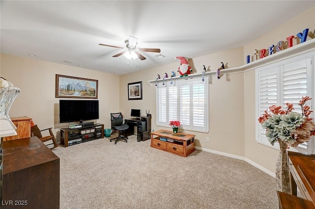 carpeted office space with ceiling fan