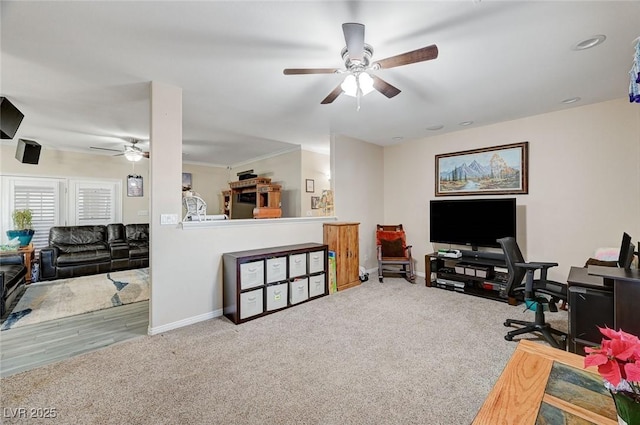 carpeted home office featuring ceiling fan