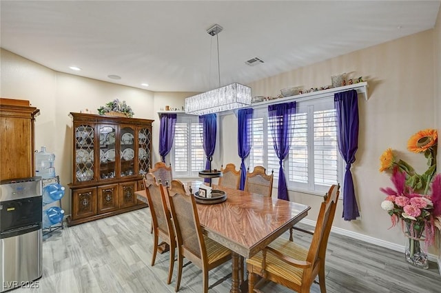 dining area featuring hardwood / wood-style floors and a healthy amount of sunlight