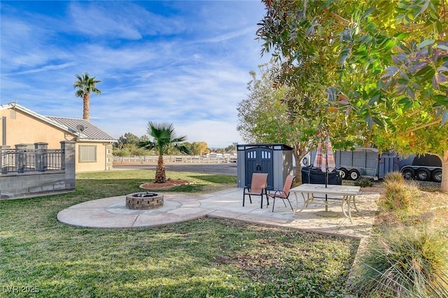 view of yard with a patio and an outdoor fire pit