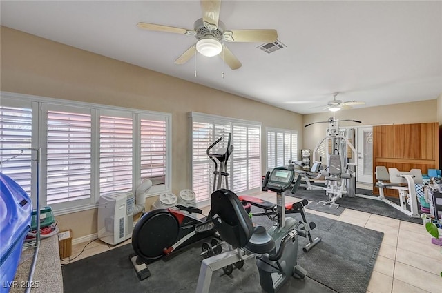 exercise room featuring plenty of natural light, ceiling fan, and light tile patterned floors