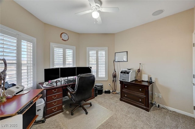 carpeted office space with ceiling fan