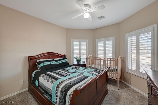 bedroom with ceiling fan and light carpet