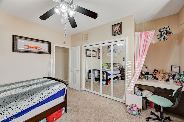 carpeted bedroom with a closet and ceiling fan