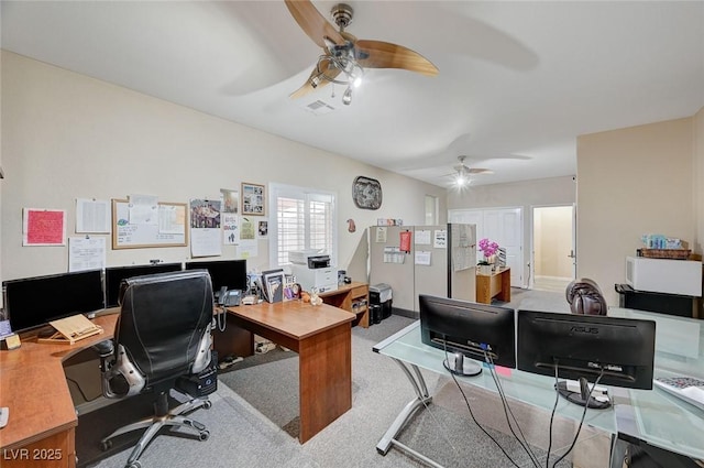 carpeted office space featuring ceiling fan